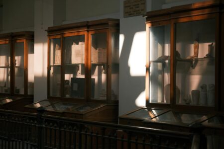 Modern museum interior with visitors browsing exhibits and retail displays