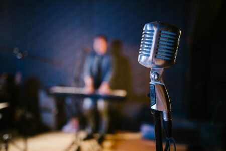 Close-up of microphone on stage with dramatic lighting for live performance
