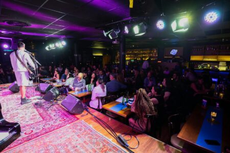 Interior view of a comedy club with stage lighting and seating area