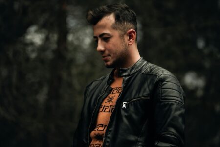 Close-up of a weathered brown leather jacket showing natural patina and character marks