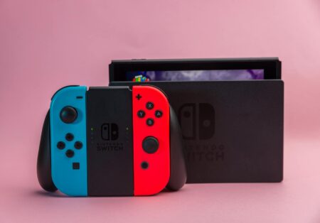 Modern handheld gaming device displaying colorful indie game on screen