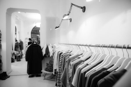 High-end clothing items hanging in a minimalist closet showcasing quiet luxury fashion