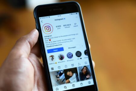 Person using smartphone to browse social media content
