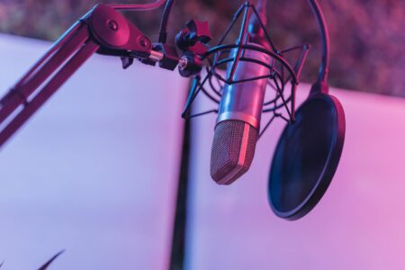 Professional podcast recording setup with microphone and headphones in broadcast studio
