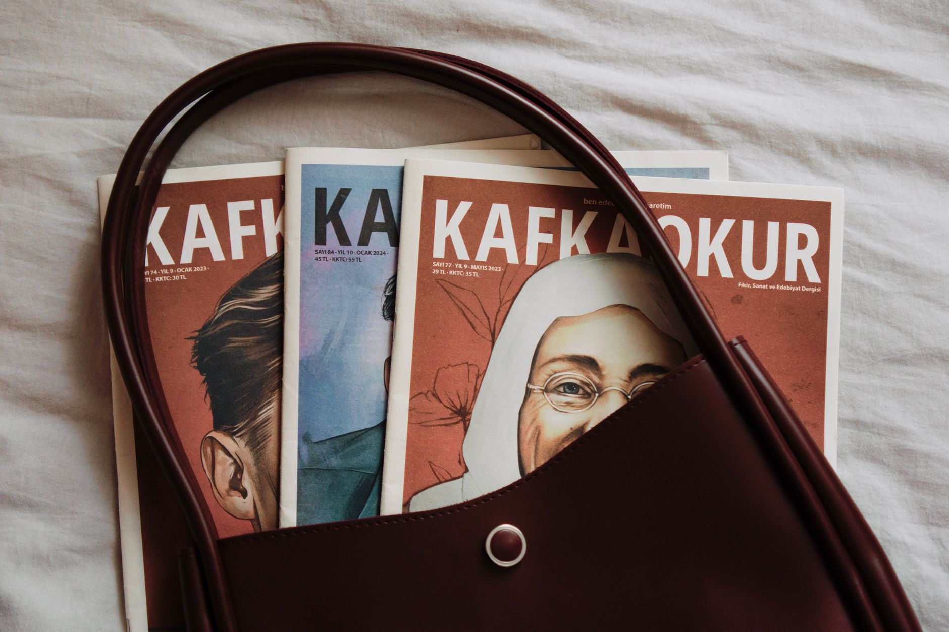 Open pages of a literary magazine spread on a wooden desk