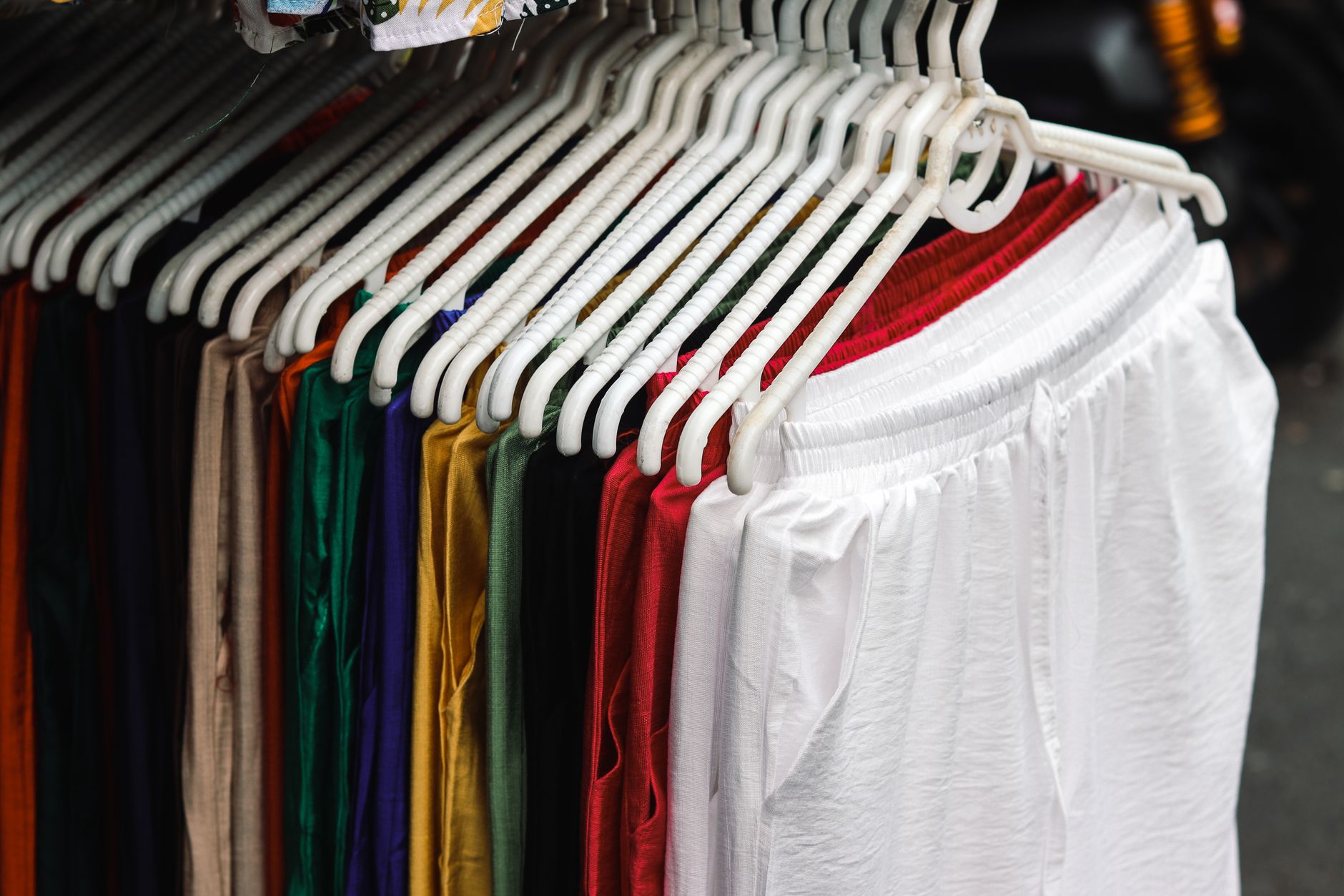 Vibrant street fashion stall with colorful clothing on display