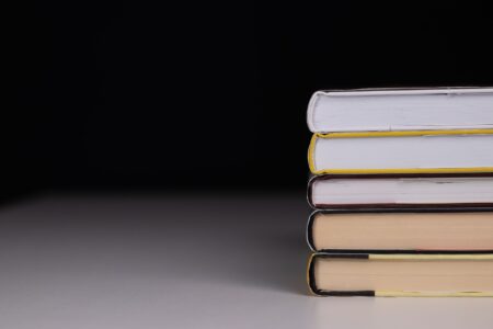Evil Twin and The Black List Offer $25,000 for Your Horror Manuscript A dark, atmospheric hardcover book on a shadowed surface suggesting horror fiction