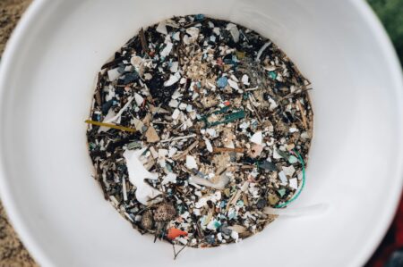 Scattered brightly colored plastic fragments on a natural surface
