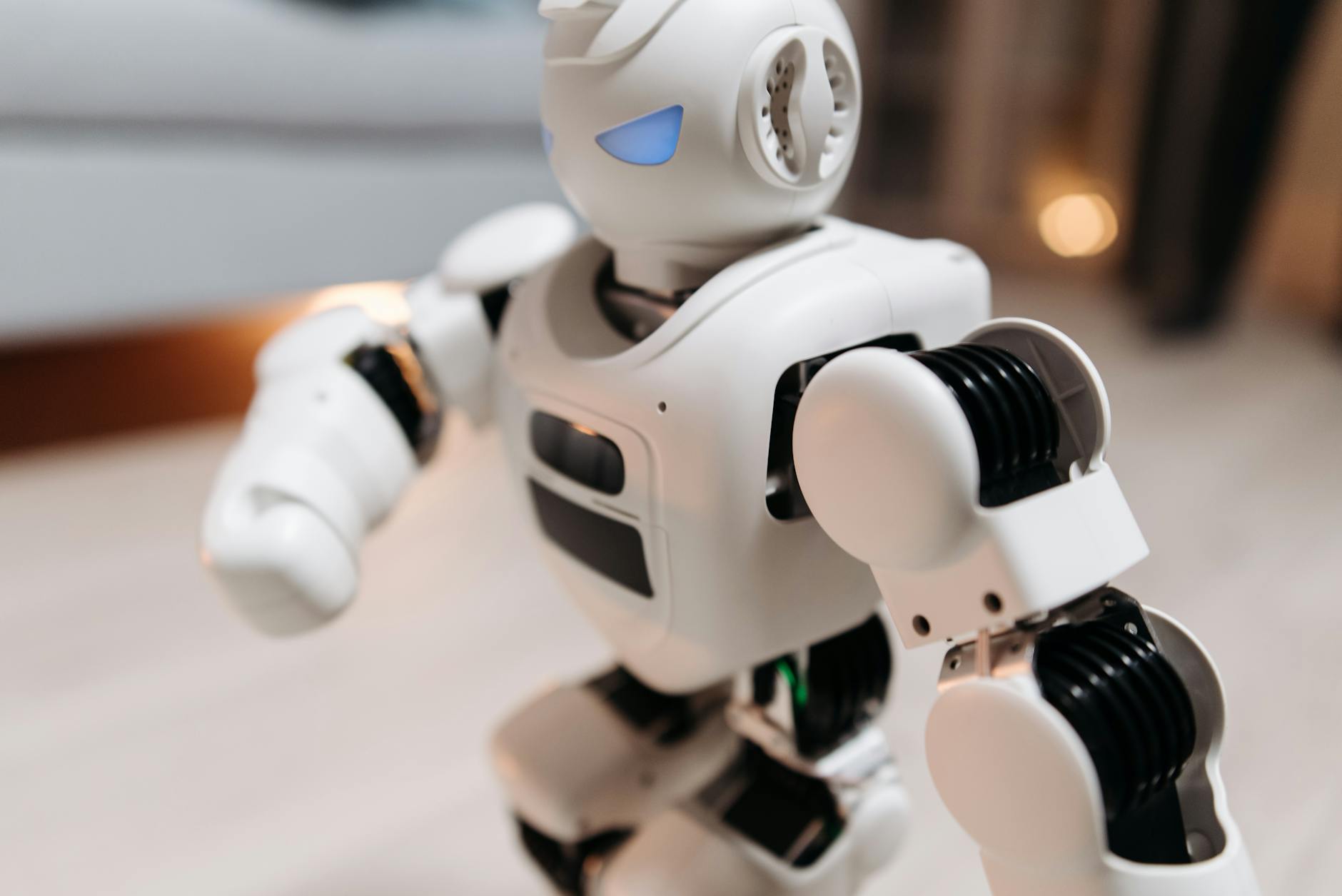 A humanoid robot standing in an industrial warehouse environment
