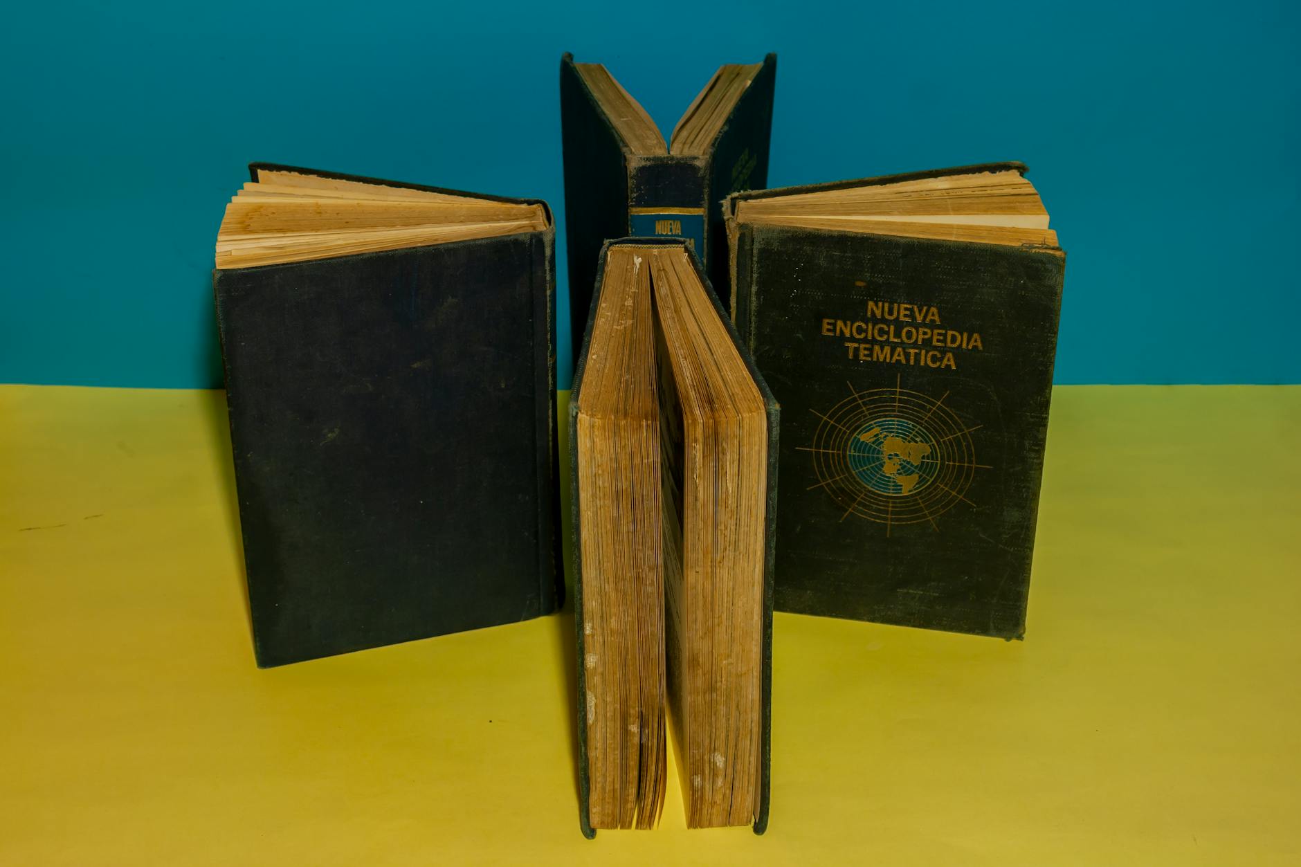Stack of open vintage books on a wooden table suggesting literary history