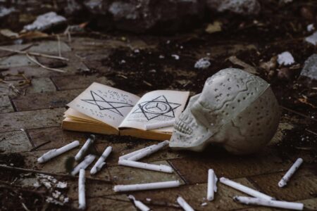 Stephen Graham Jones and Ryan Coogler Lead the 2025 Bram Stoker Winners Dark atmospheric book open on a table with dim candlelight