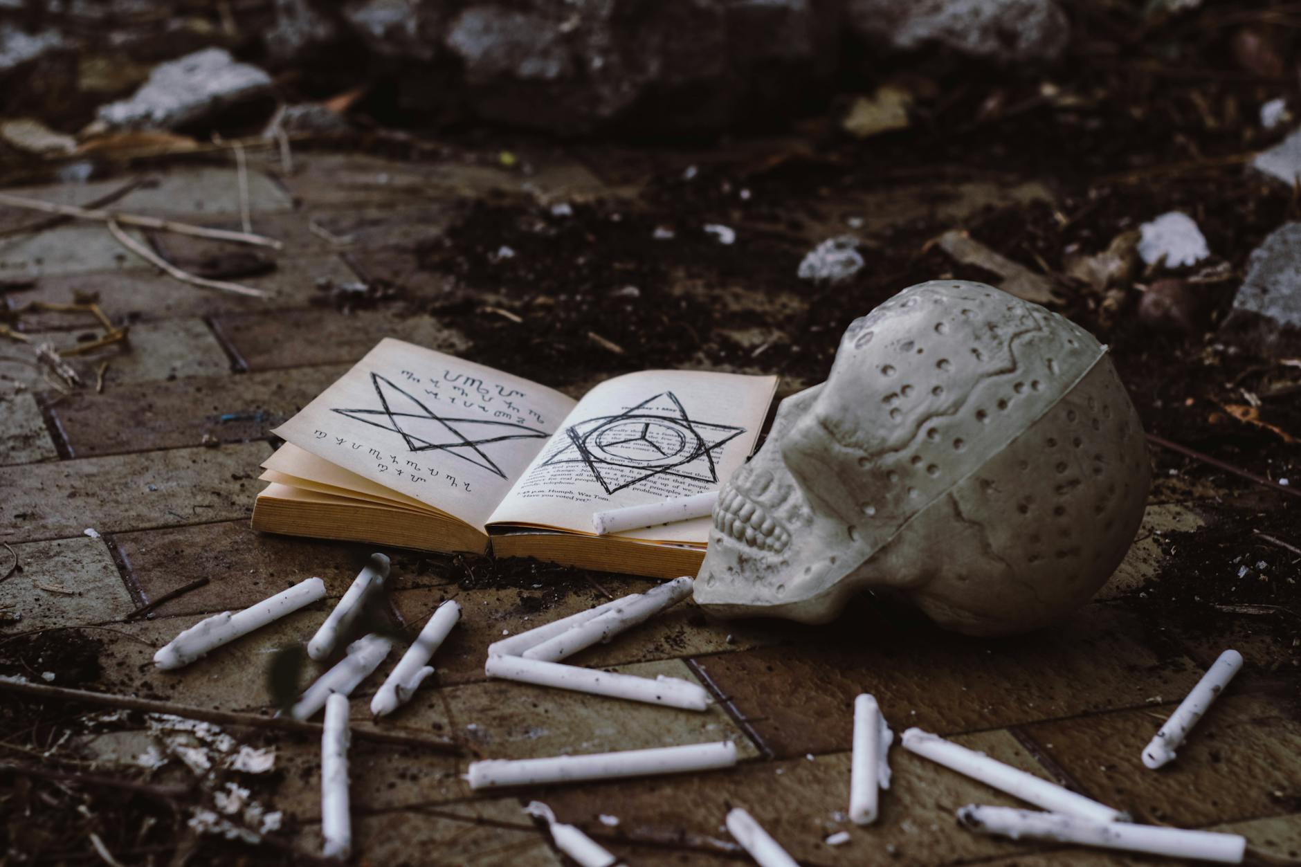 Dark atmospheric book open on a table with dim candlelight