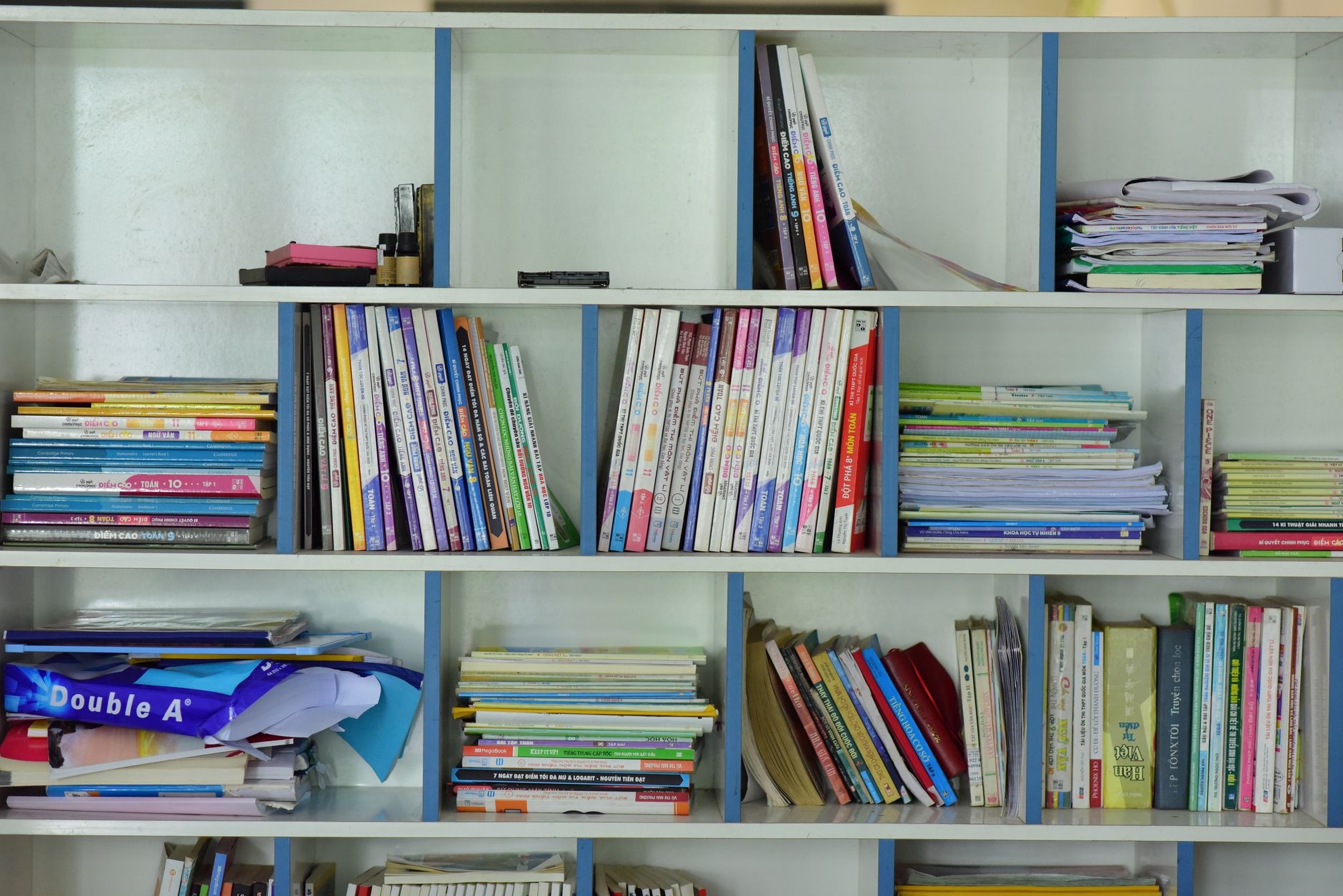 Empty shelves in an underfunded school library with few books visible
