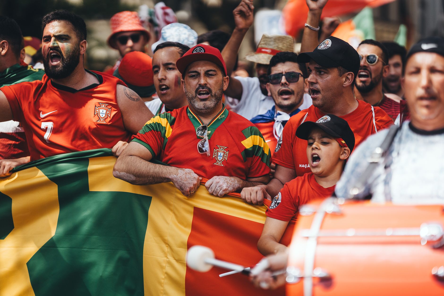 Football supporters waving flags in the stands at an international tournament