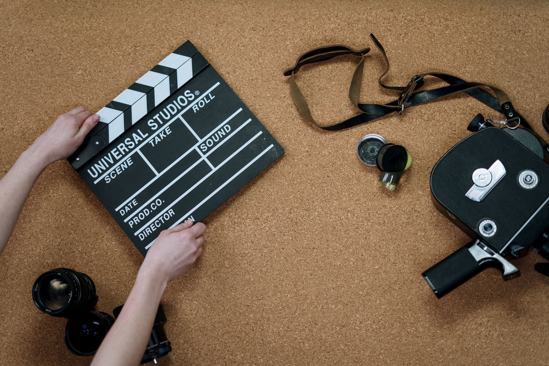 A film director standing behind a camera on a professional movie set