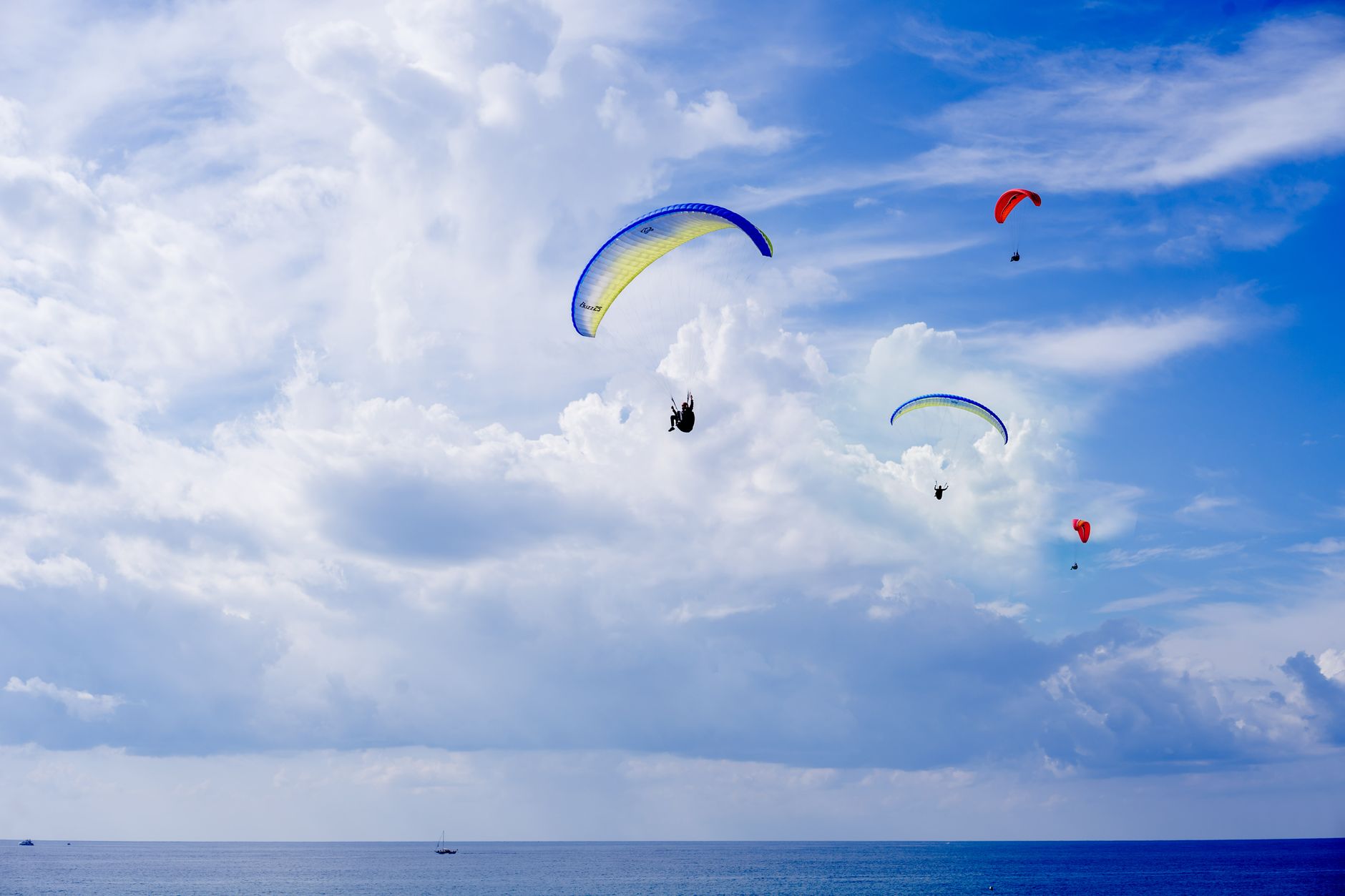 Parachute descent over open ocean representing a spacecraft splashdown recovery