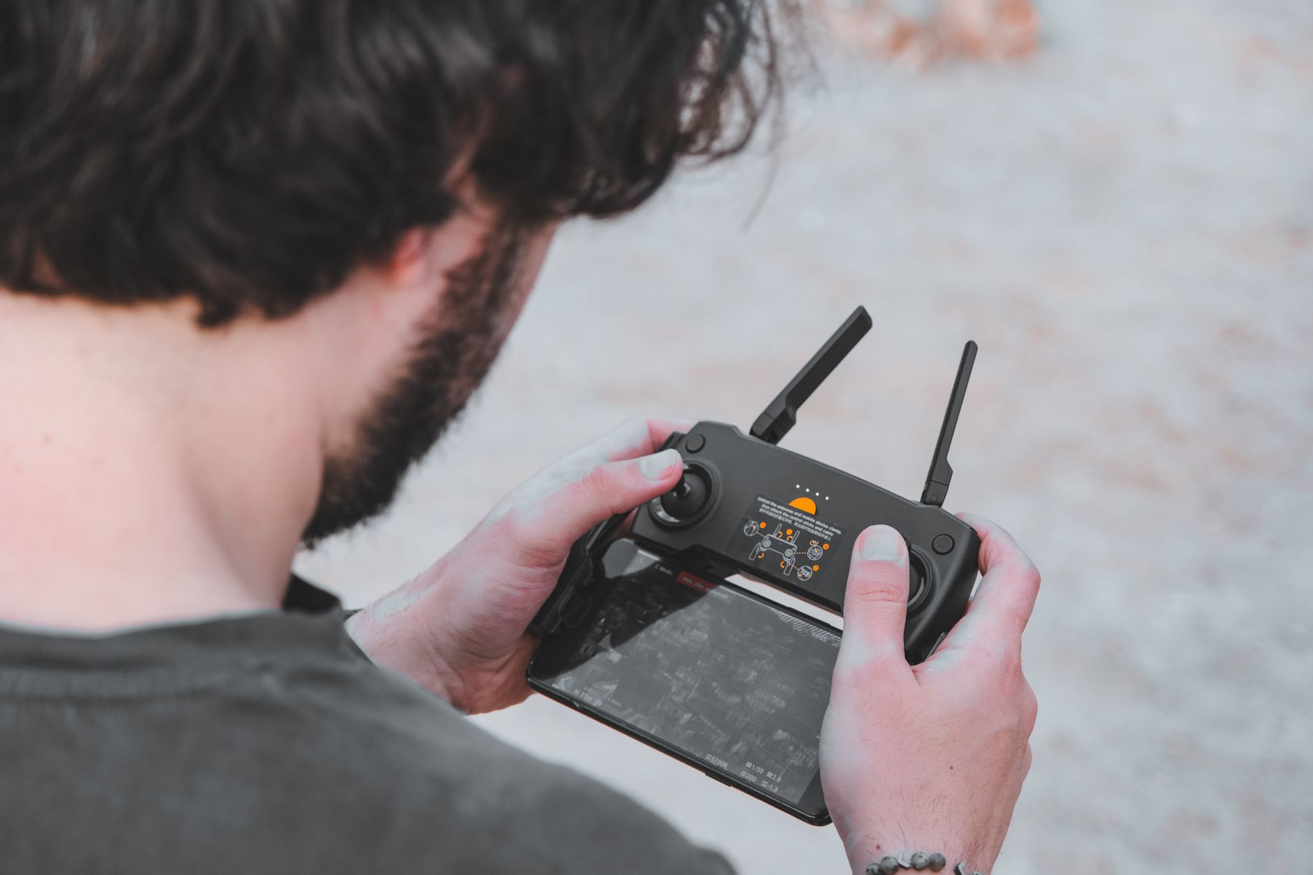Soldier operating a drone controller outdoors during training exercise