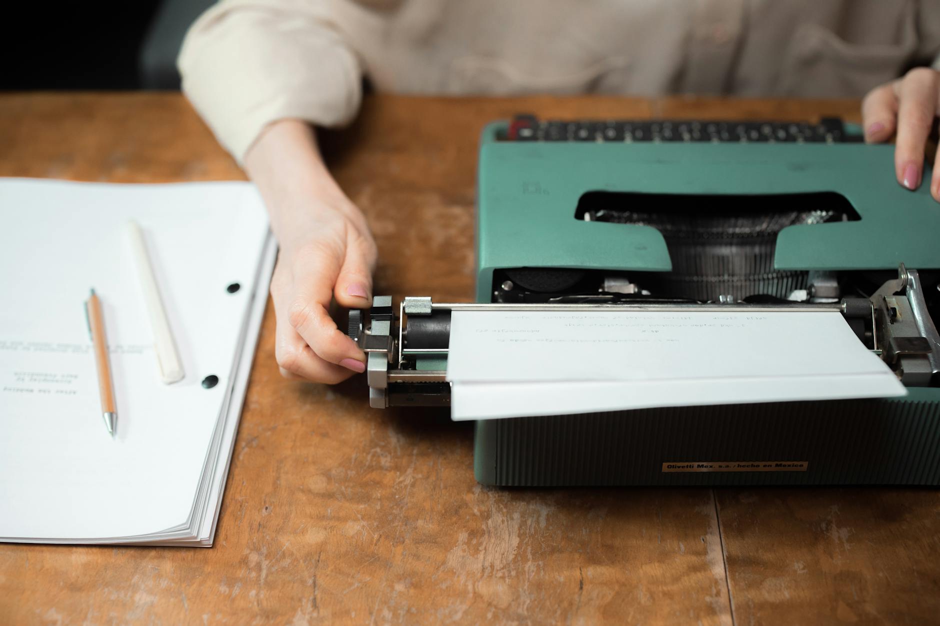 Vintage typewriter with blank paper on a wooden writing desk