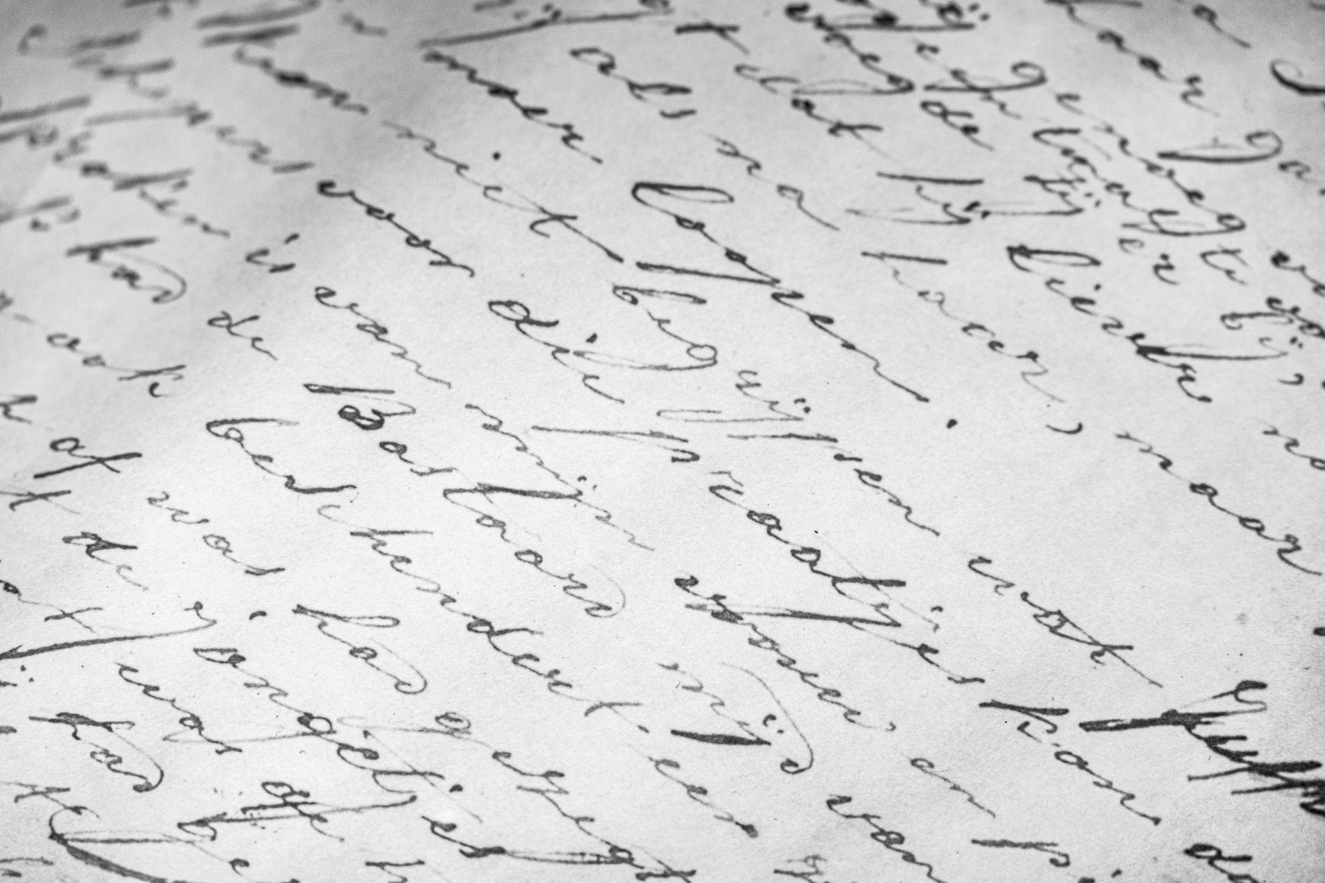 Close-up of aged handwritten parchment documents with faded ink