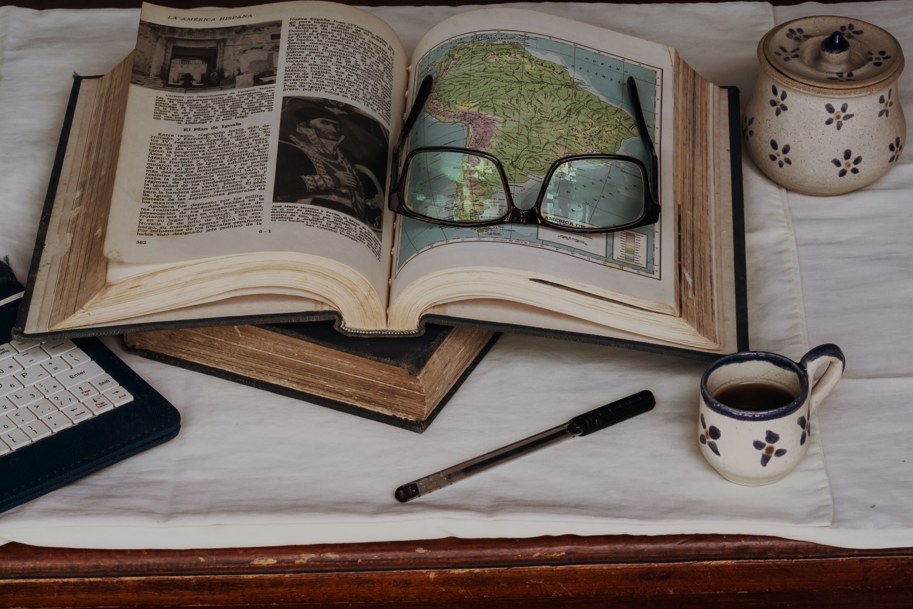 An open memoir or hardcover book resting on a wooden table in natural light