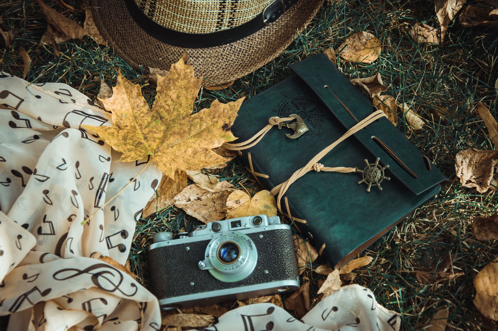 Handwritten travel journal open on a table with a pen beside it