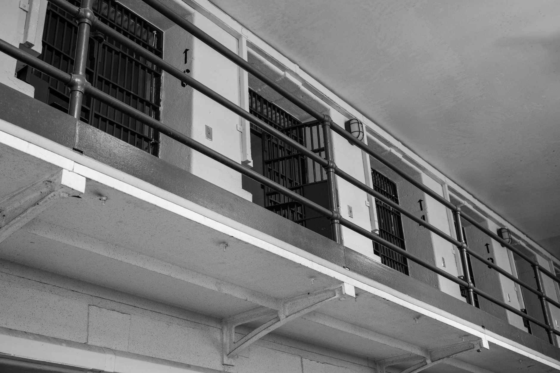 An exterior view of a secure government detention facility with fencing