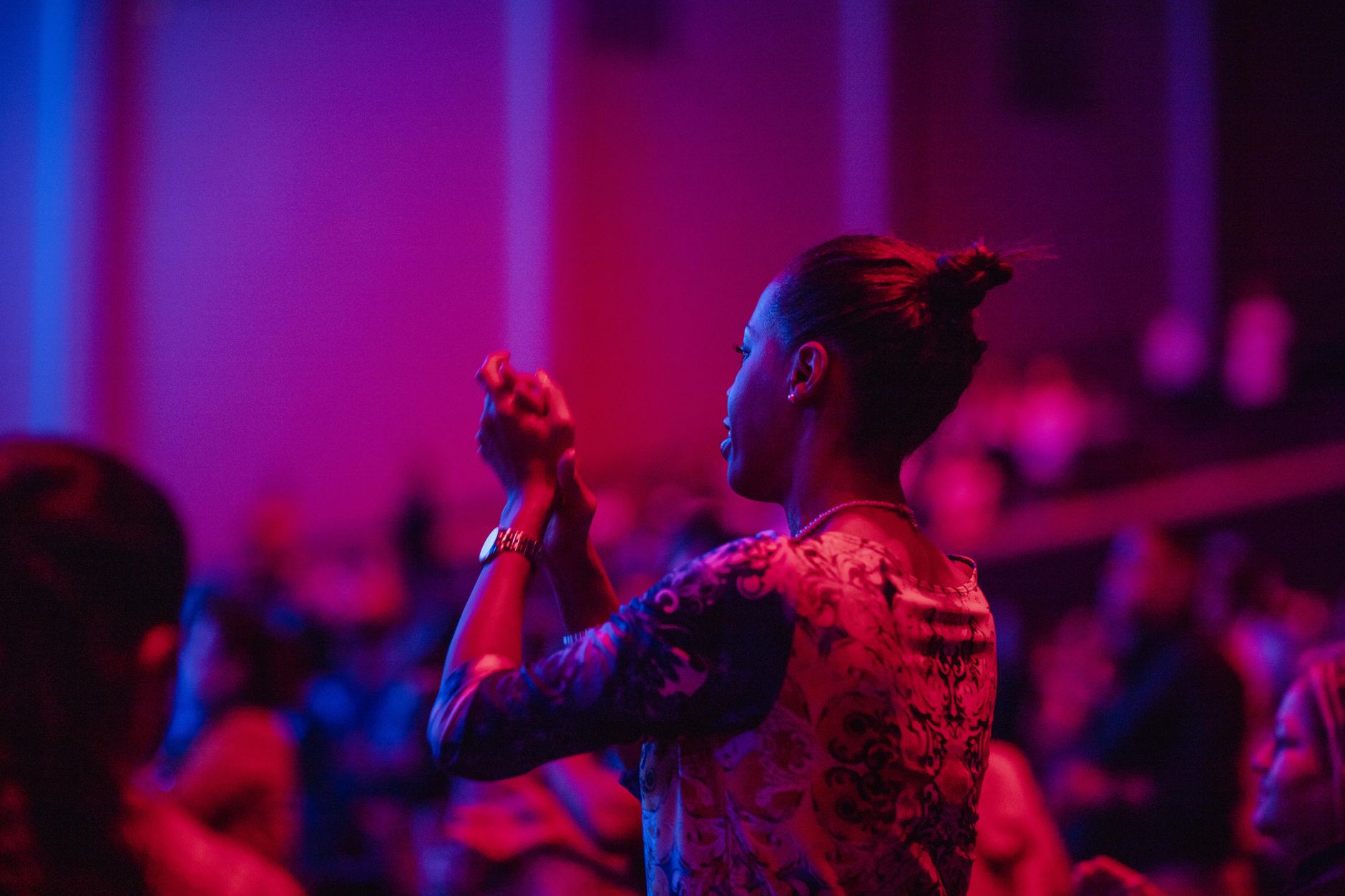 Theater audience applauding at the end of a live stage performance