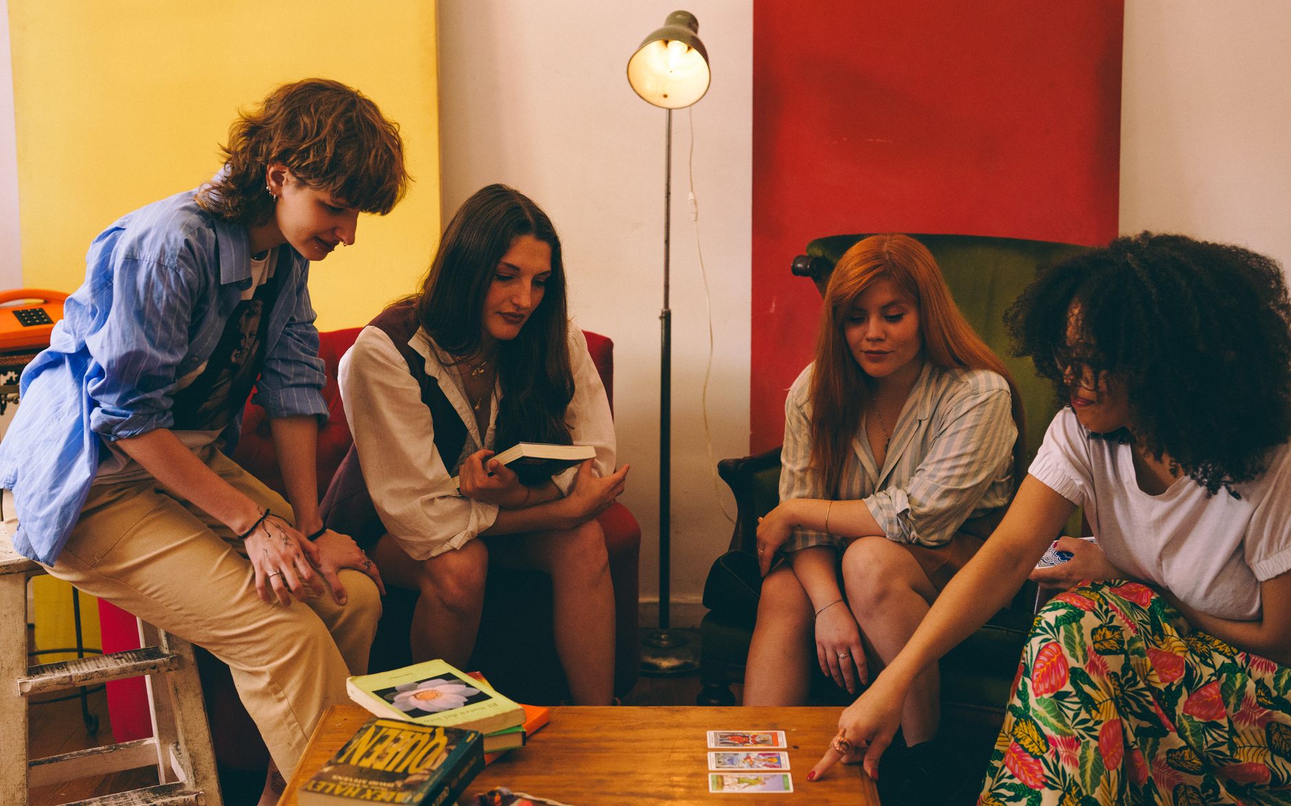 Small group of people gathered around a table with open books in discussion