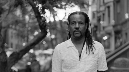 A view of a Harlem street in New York City, evoking the neighborhood setting of Colson Whitehead's crime trilogy