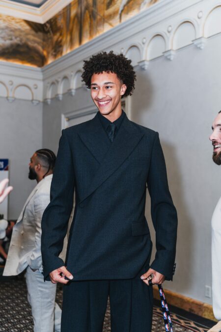 Young athlete in a tailored suit at a formal sports event