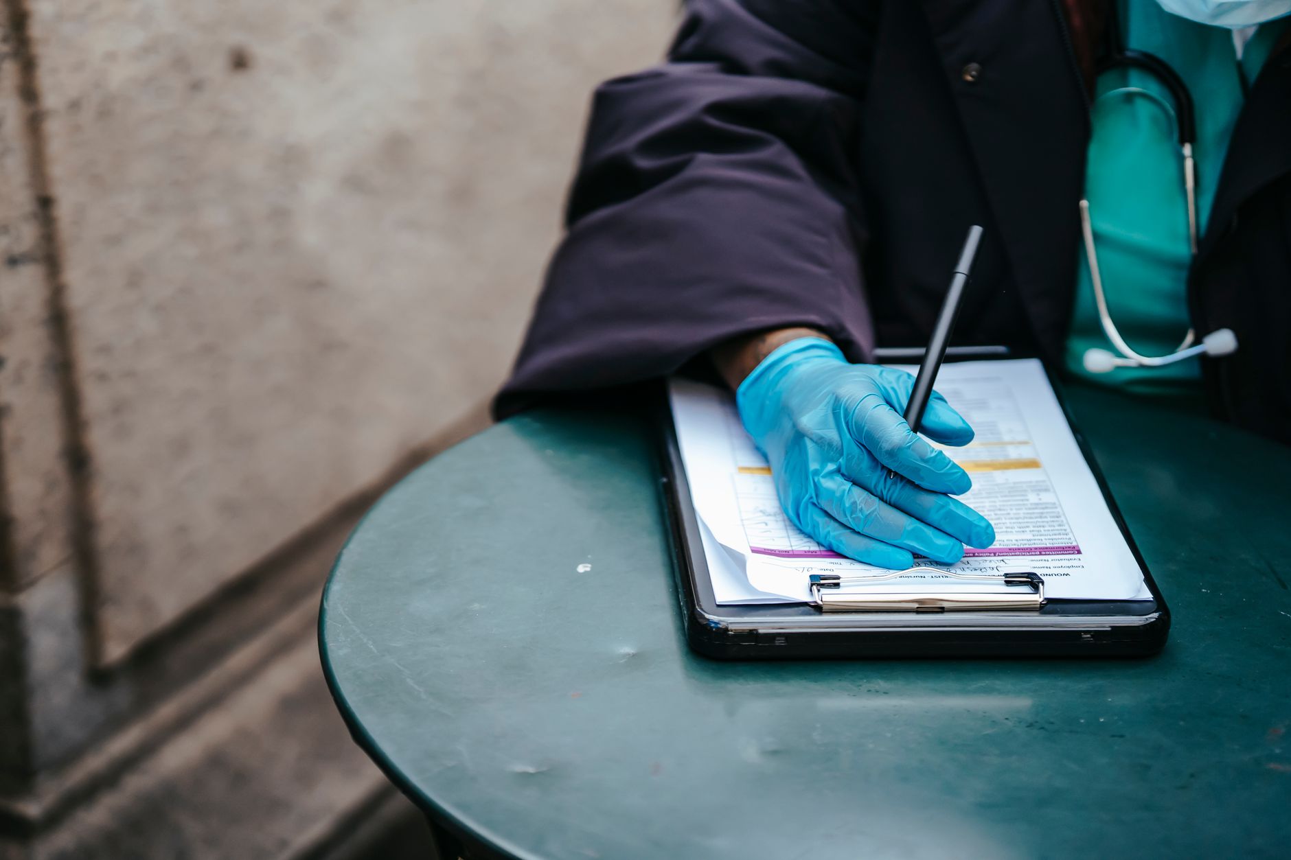 A physician reviewing paperwork at a medical office desk