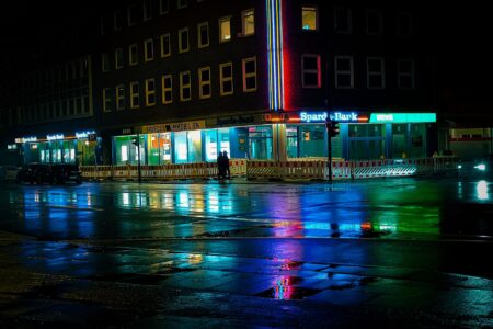 Dark neon-lit cityscape at night evoking a cyberpunk aesthetic