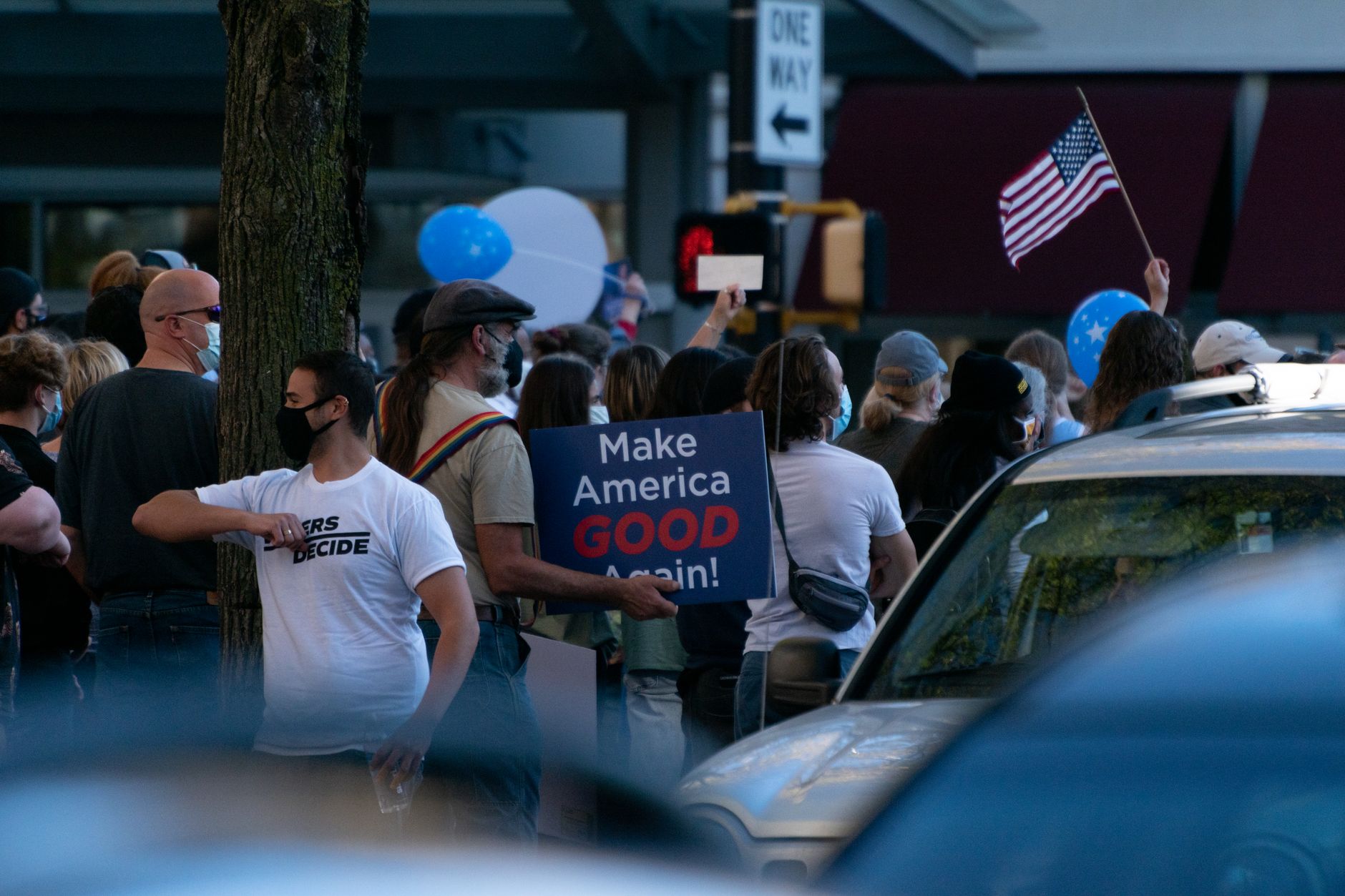 People gathered beneath an American flag at a public event