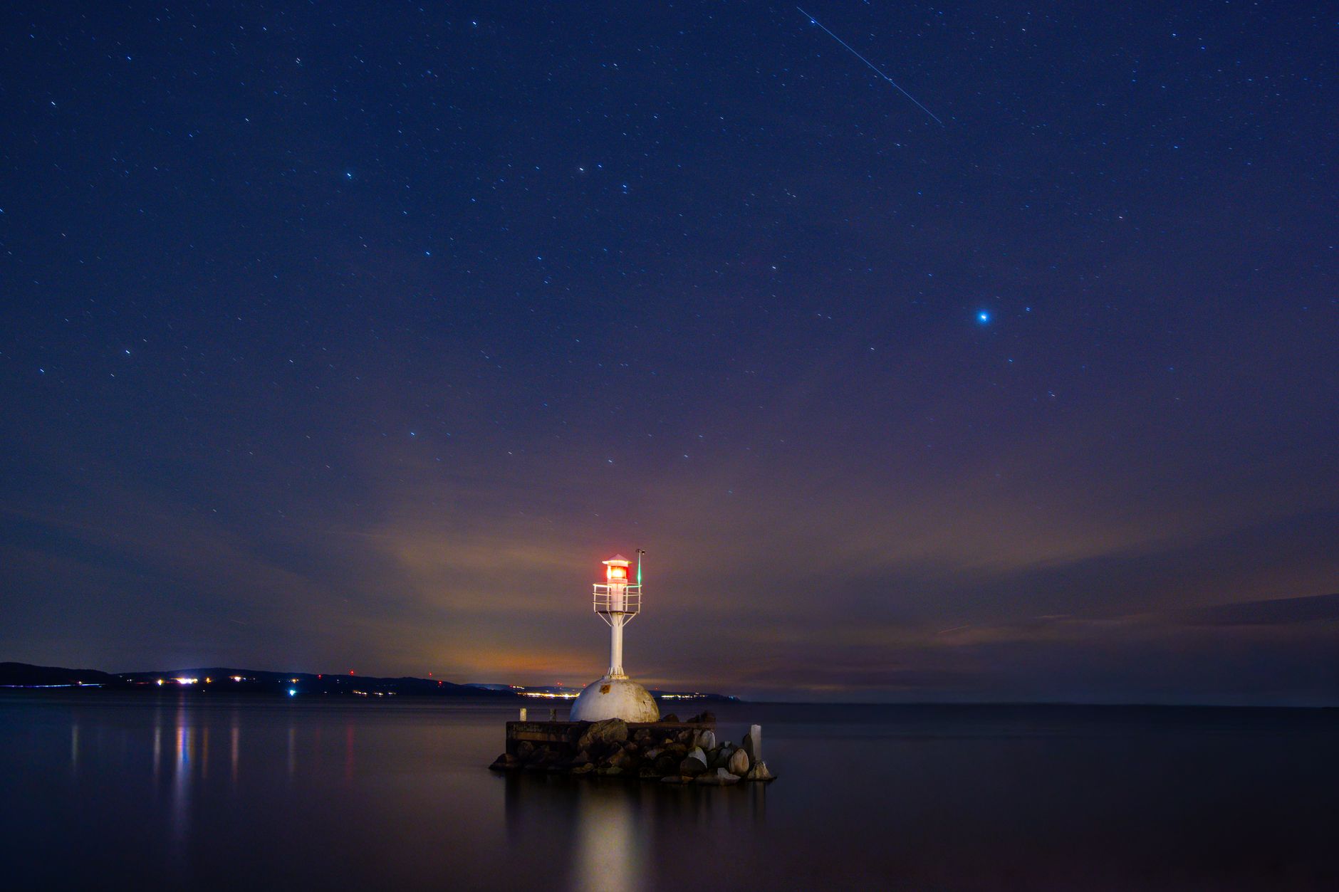 Star trails over open ocean horizon suggesting traditional wayfinding