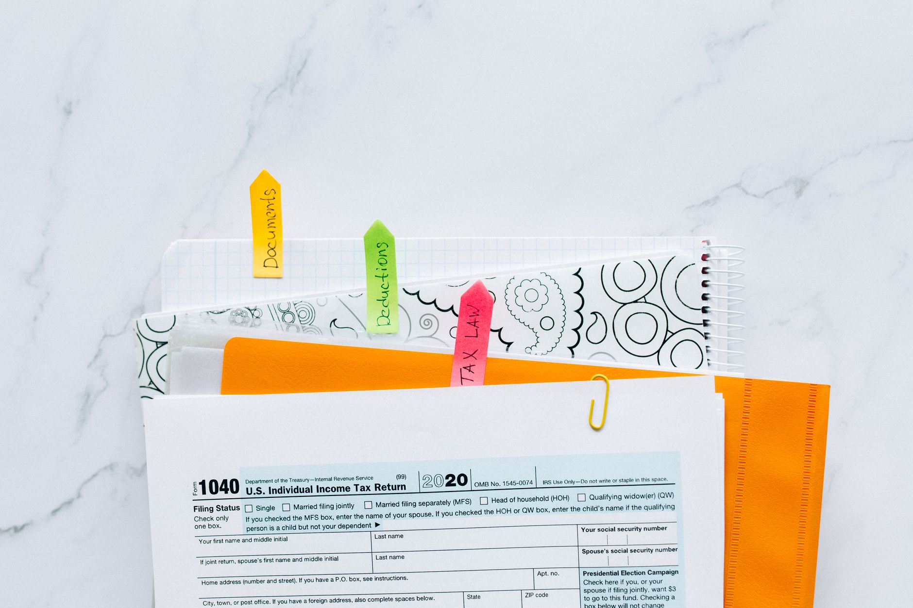 Printed documents with black redaction marks covering portions of the text
