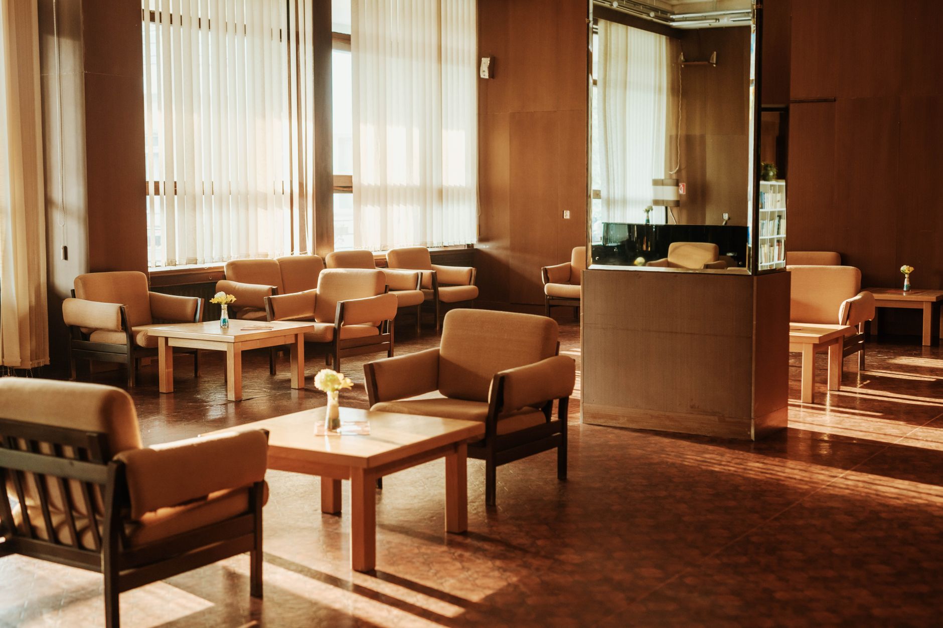 Patients waiting in a hospital waiting room under fluorescent lighting