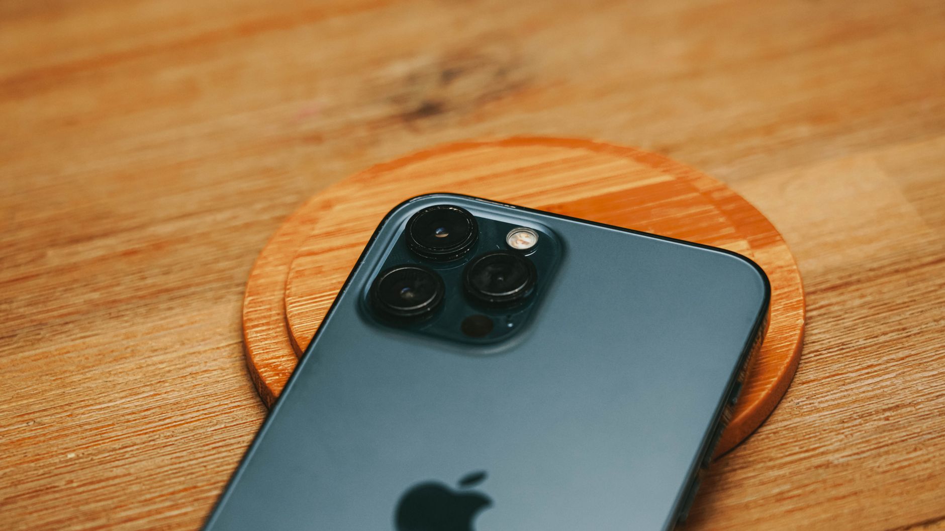 Person holding a smartphone with camera lens visible, representing personal device photography