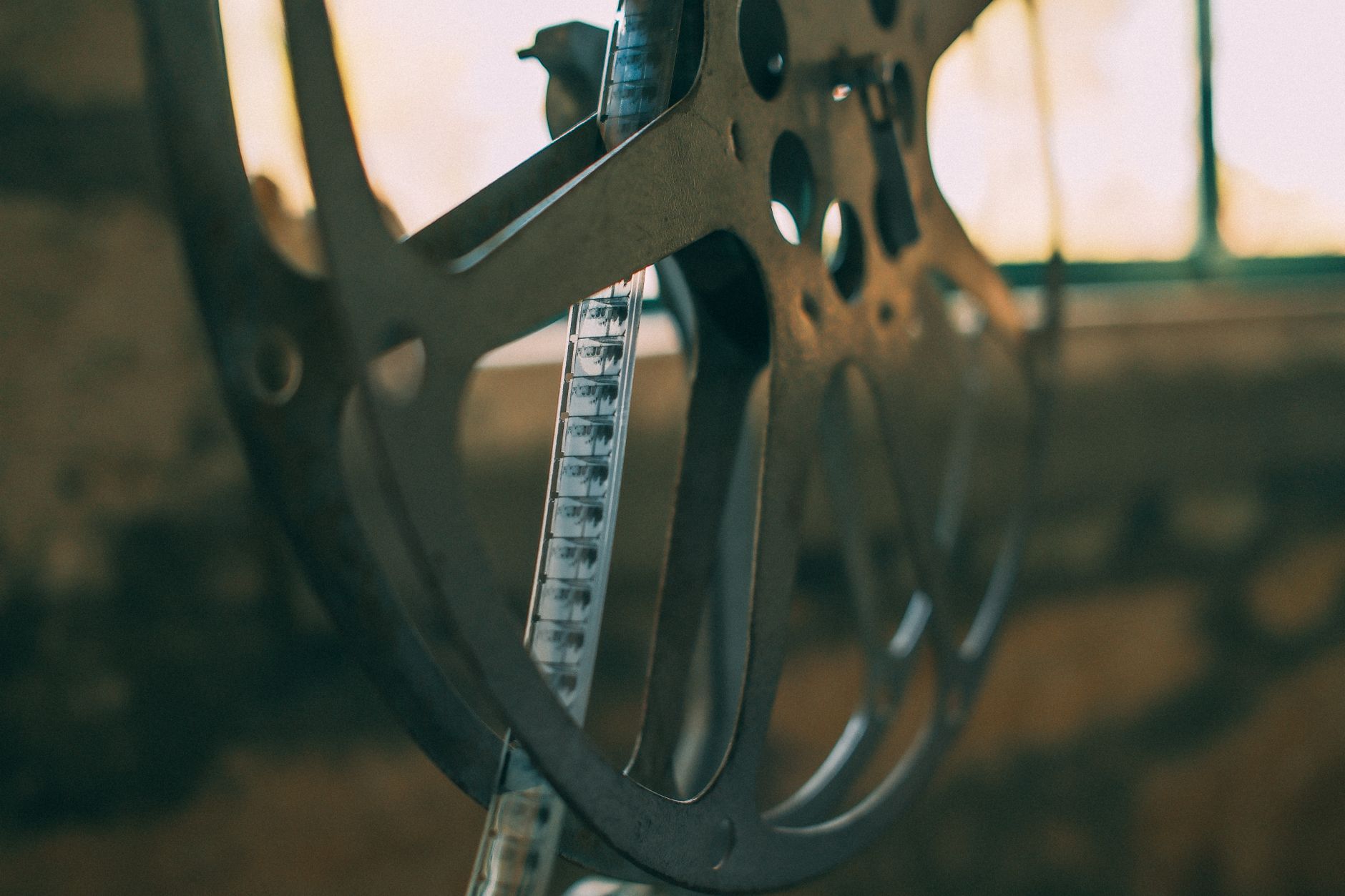 A vintage film reel and camera suggesting documentary filmmaking