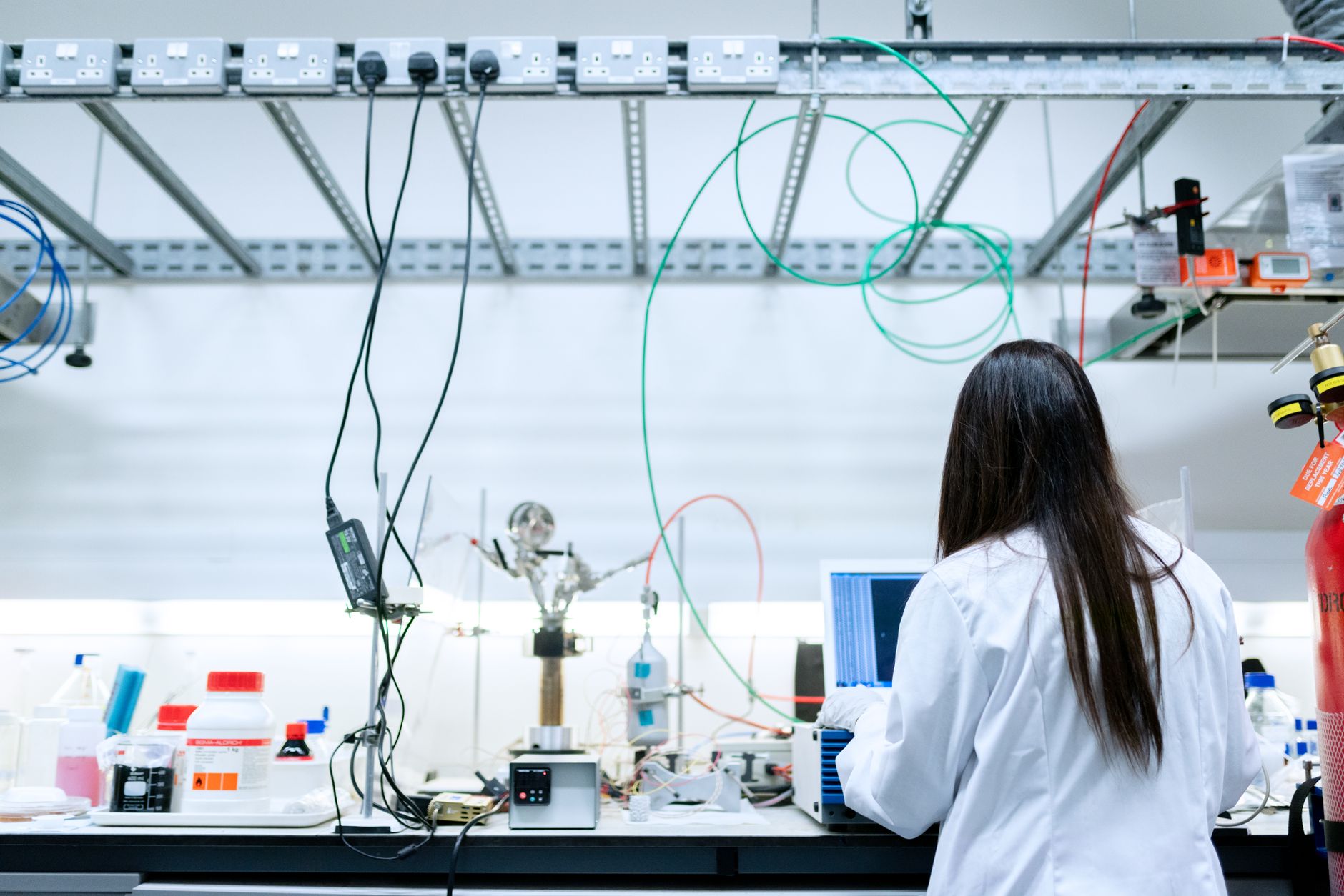 Engineer examining circuit board in a technology research facility