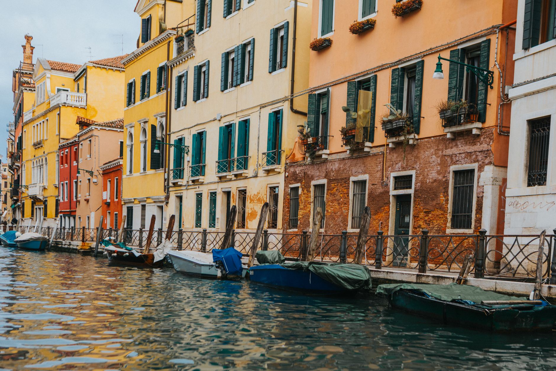 Venice waterway at dusk with classical facades reflected in still water