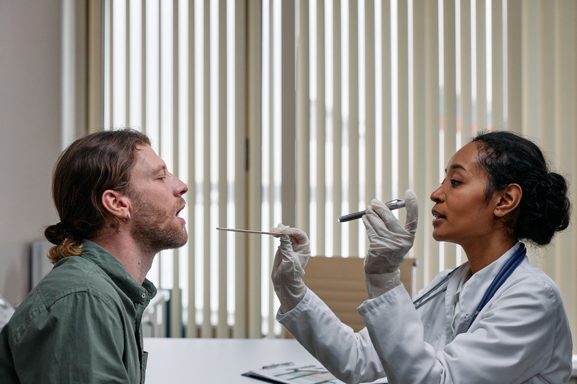 A man speaking with a physician during a routine health checkup appointment