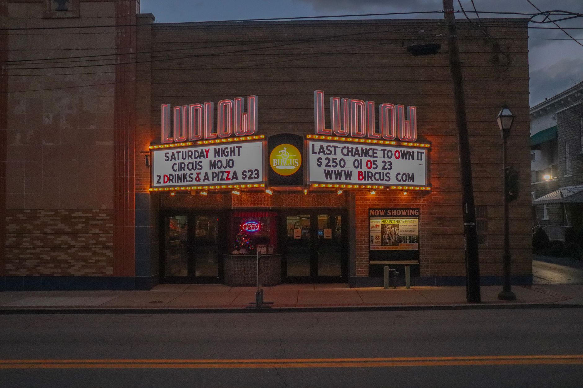 Illuminated cinema marquee at night representing blockbuster franchise releases