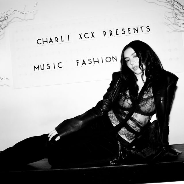Dark and moody fashion editorial photograph with dramatic shadow and texture