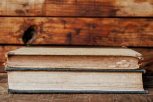 A collection of colorful vintage book covers arranged on a wooden surface