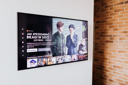 A large smart TV powered on in a dimly lit living room