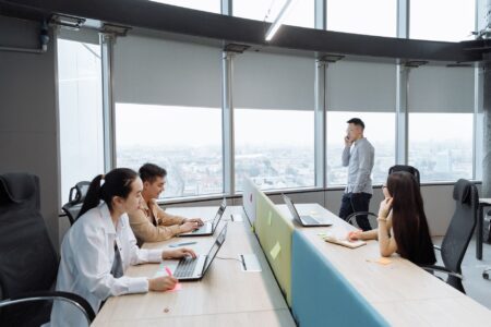 Office workers sitting at desks in a modern open-plan Manhattan office