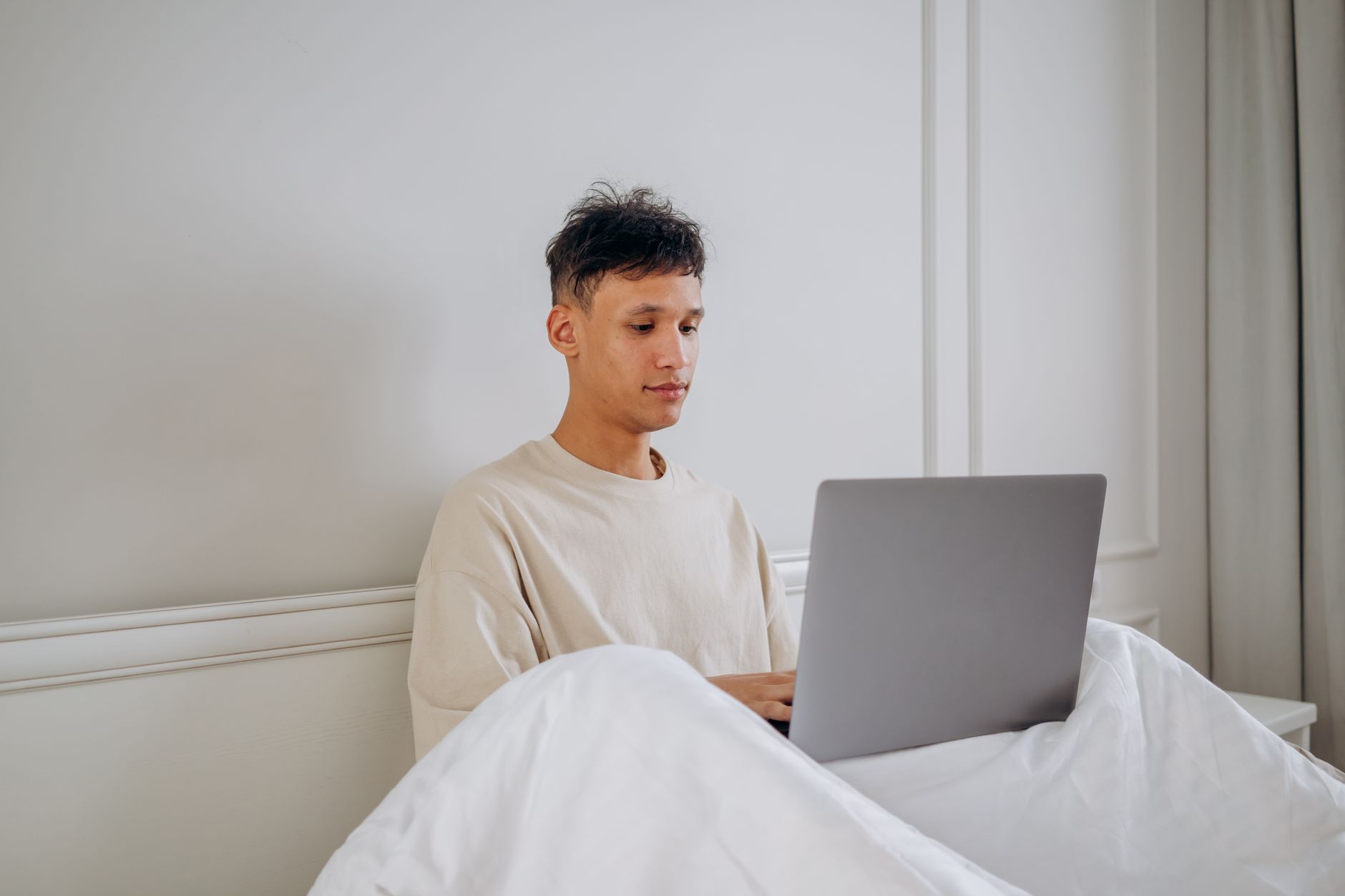 Person browsing a fashion website on a laptop at a desk