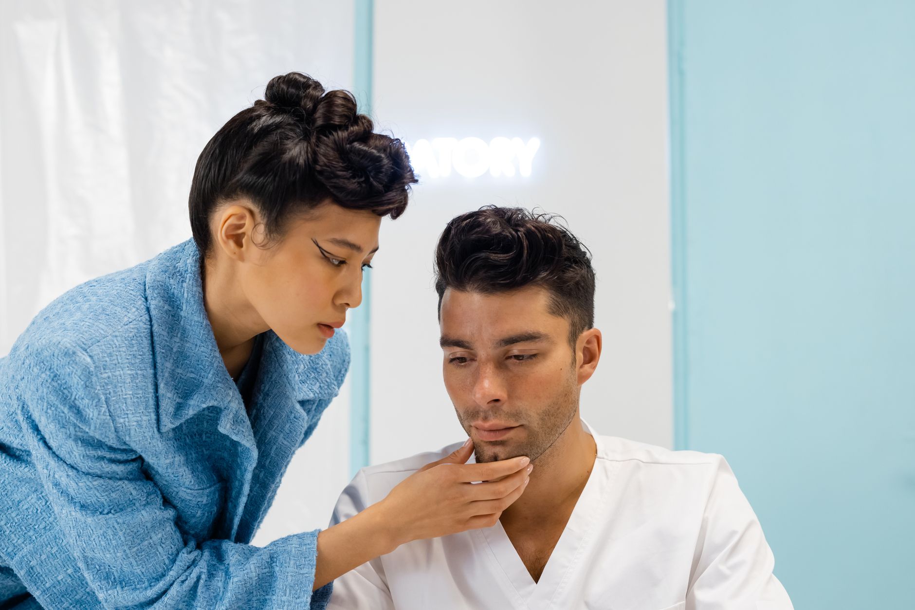 A doctor examining a young patient's skin in a clinical setting