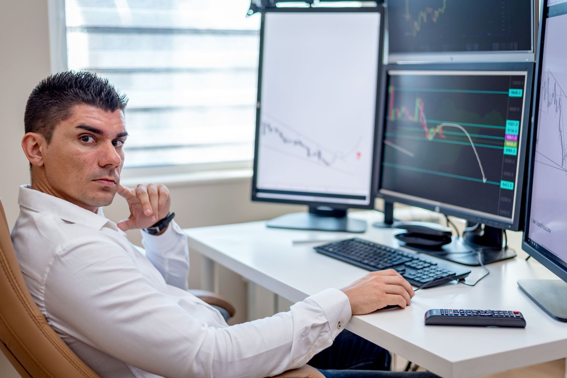 An analyst reviewing documents at a workstation in a security operations setting